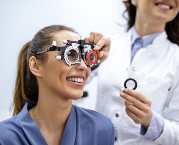 Ophthalmologist,Examining,Woman,With,Optometrist,Trial,Frame.,Female,Patient,To